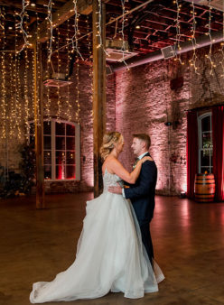 Bride and groom share dance under fairy lights
