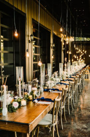 Long farmhouse table setup on Lakeview Event Center patio with Edison bulb lighting